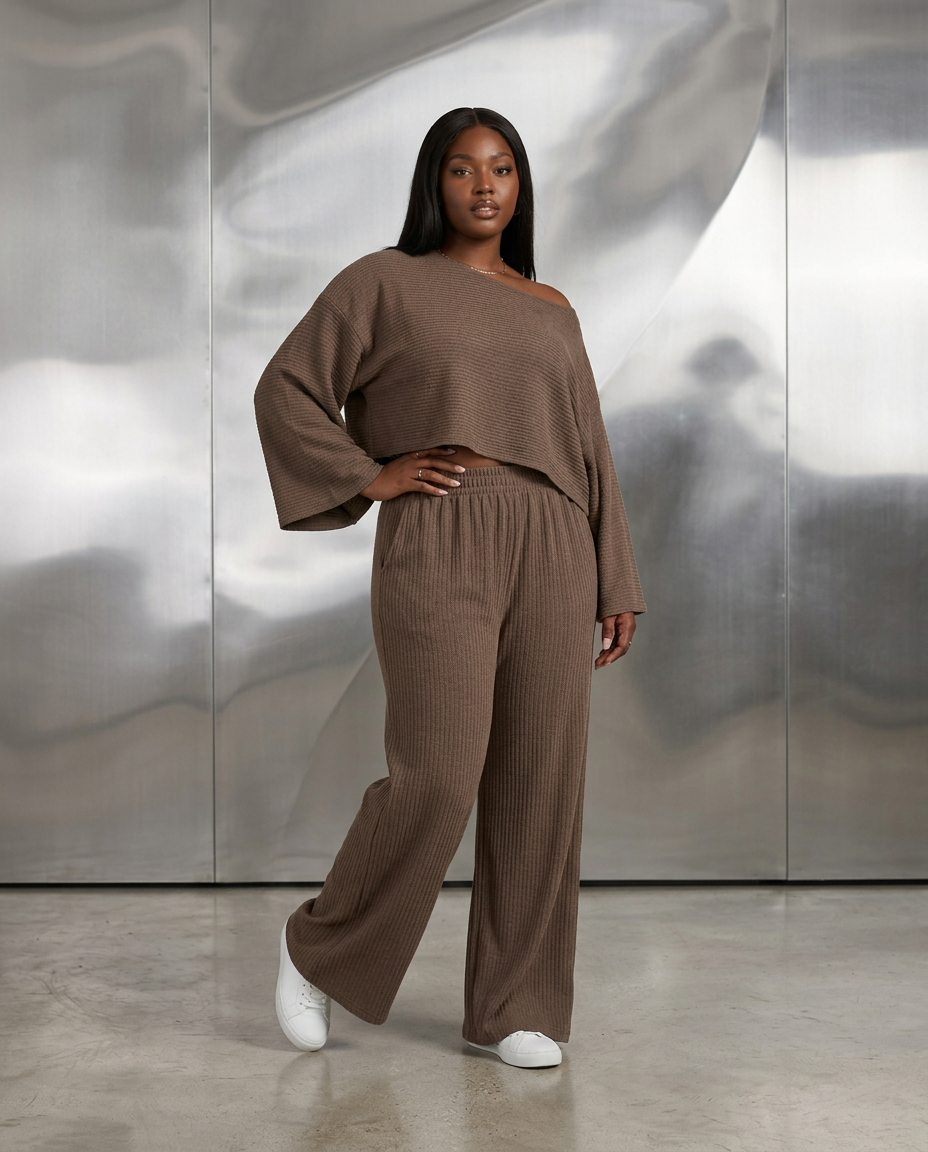 Black model wearing our Mocha Drape matching set in a sculptural studio